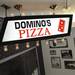 An old Domino's Pizza sign hangs in the lobby at headquarters in Ann Arbor. Domino's had originally planned to place a dot for every store in the domino in the logo.  Melanie Maxwell I AnnArbor.com